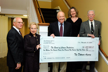 Freeholder Lillian Burry holds the final reimbursement check for the Thompson Park Visitor's Center